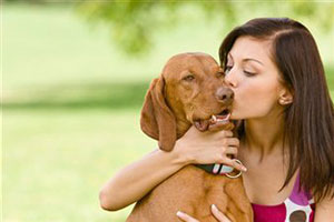 Девушка целует собаку