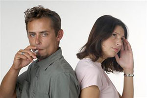 Мужчина курит рядом с женщиной