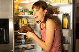 Девушка полезла в холодильник за сладостями