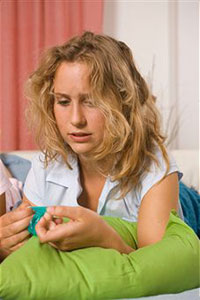 Девушка держит противозачаточные таблетки