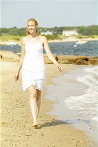 Девушка в отпуске гуляет по пляжу