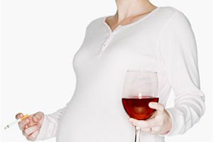 Беременная девушка с бокалом вина и сигаретой в руках
